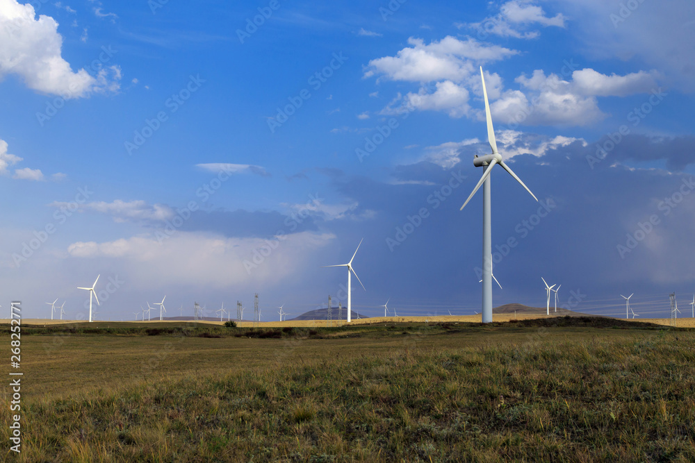 A windmill that generates electricity on the prairie A windmill that generates electricity on the prairie