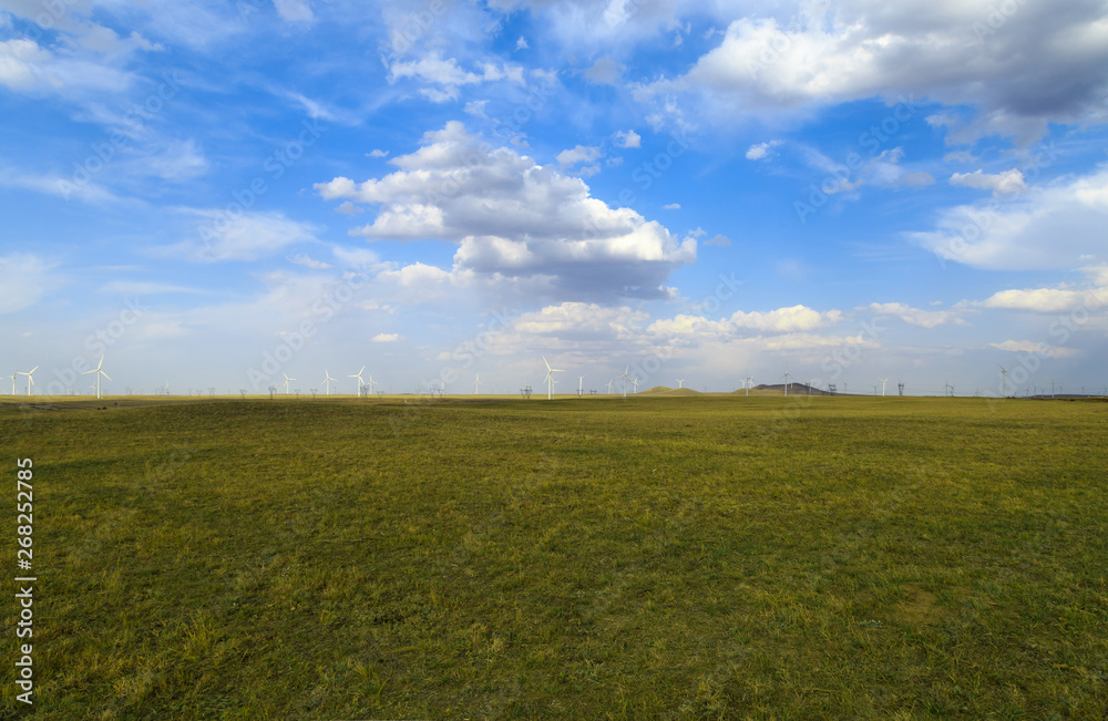 A windmill that generates electricity on the prairie