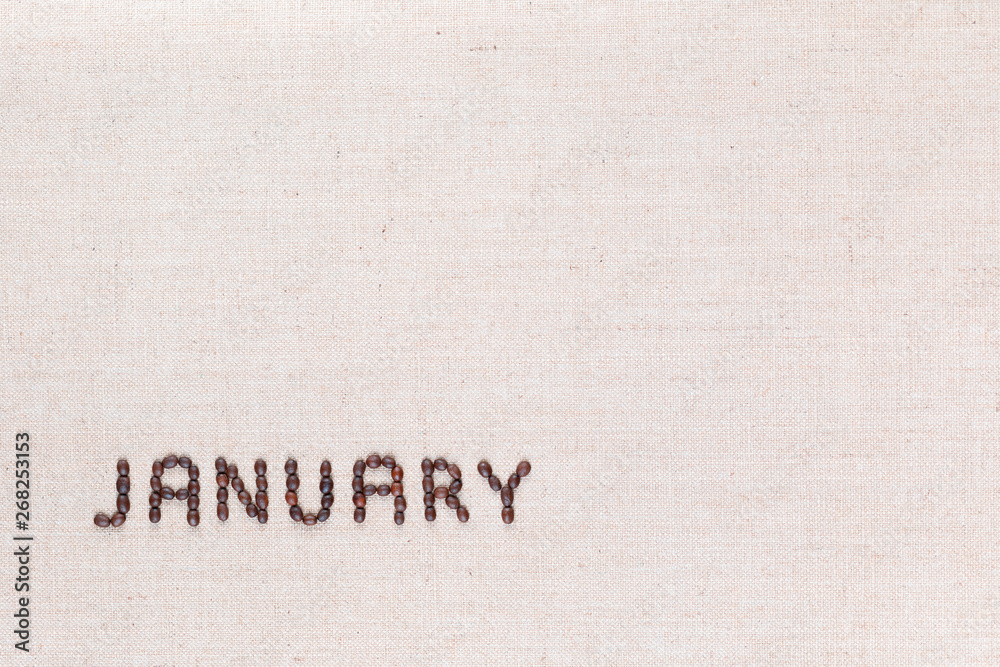 The word January written with coffee beans shot from above, aligned at the bottom left.