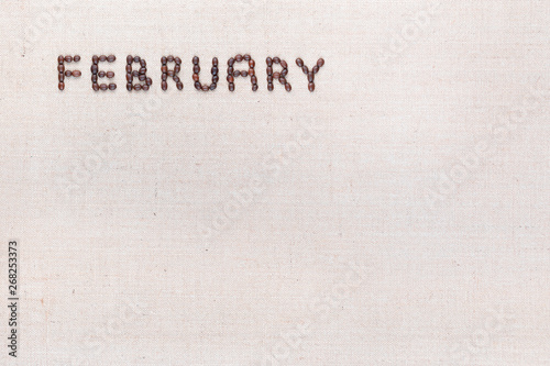 The word February written with coffee beans shot from above, aligned at the top left.