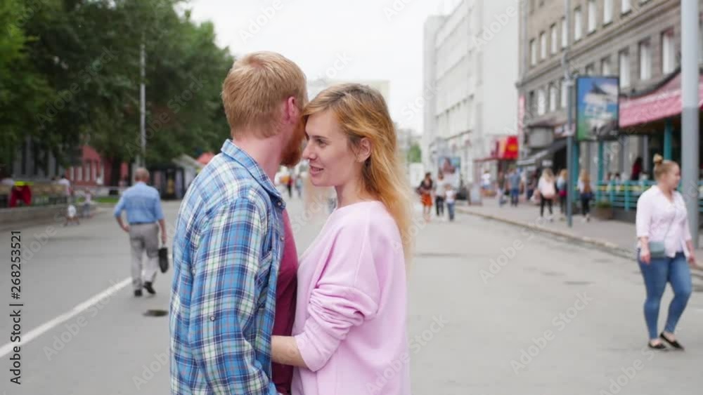 Young couple in love, hugging on the street. Selective focus. woman and man stand on the background of the city Young couple in love, hugging on the street. Selective focus. woman and man stand on the background of the city