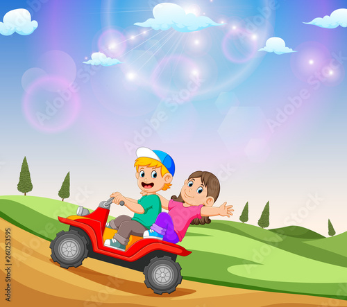 the children are riding the ATV with the beautiful view
