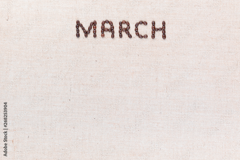 The word March written with coffee beans shot from above, aligned at the top.