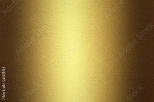 Light shining on golden metallic plate in dark room, abstract texture background
