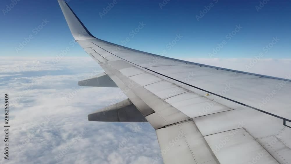View of a Plane wing high up in the sky View of a Plane wing high up in the sky