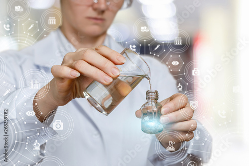 A lab worker mixes substances . photo