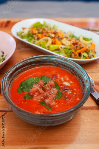Cold spanish gazpacho with basil and herbs for detox diet diner