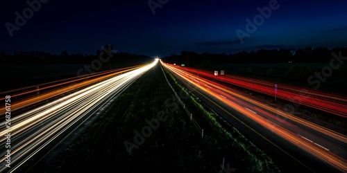 A long exposure of light streaks from cars driving on a highway at night in Indiana, USA