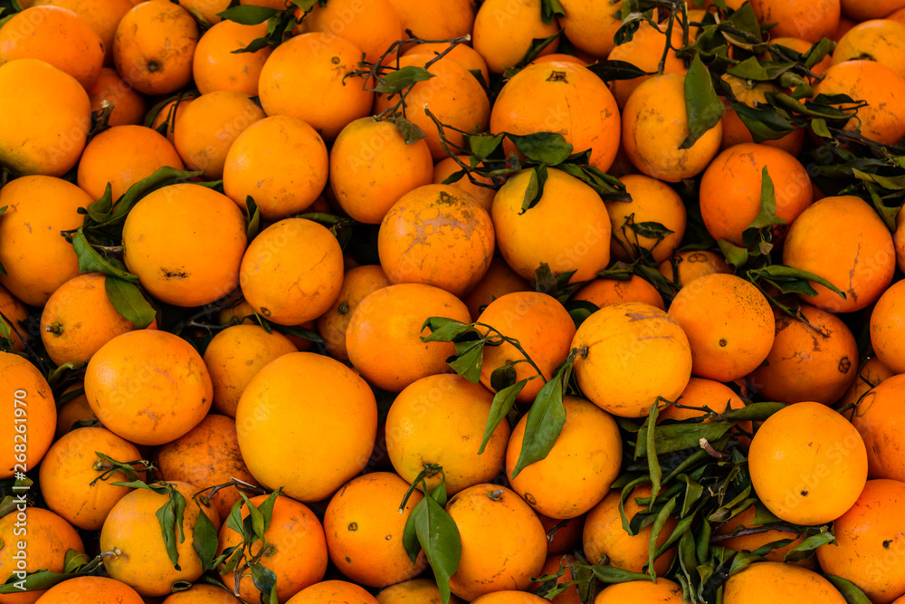 Background of the many fresh ripe orange fruits