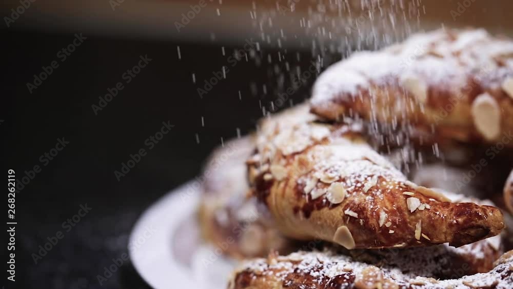 Shot speed up of beautiful almond croissants in a plate being powdered with white sugar - 1080p Slide shot from Right to Left at 120fps Shot speed up of beautiful almond croissants in a plate being powdered with white sugar - 1080p Slide shot from Right to Left at 120fps