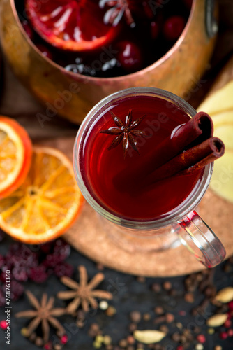 christmas hot mulled wine with cardamom and anise on wooden background