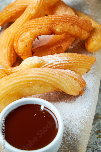 Churos spanish dessert. Gray textured background. Beautiful serving dishes. Dessert. Food chain photo