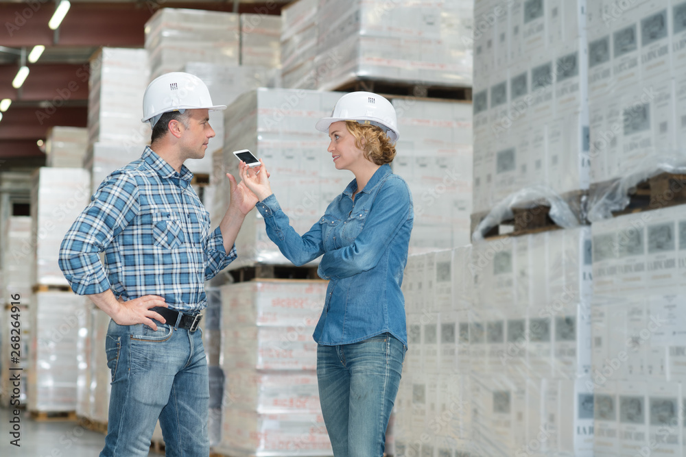 female worker managing cargo distribution boxes in storehouse