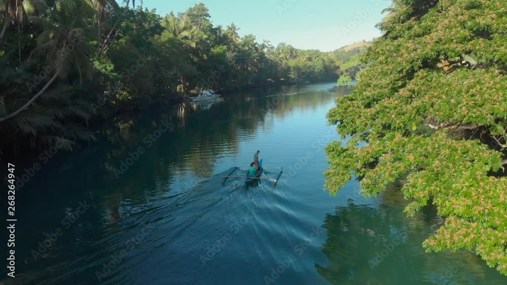 magical sunset aerial drone shot from a local boat with people on a big river through the green lush jungle forest with palmtrees magical sunset aerial drone shot from a local boat with people on a big river through the green lush jungle forest with palmtrees