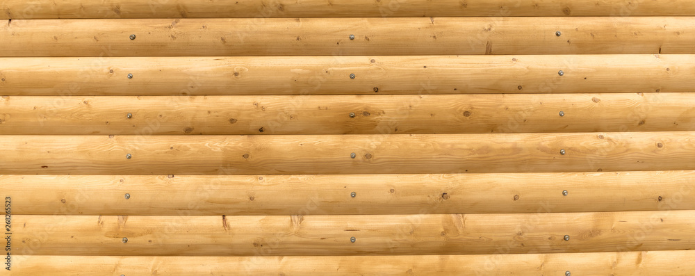 The logs are bright yellow. Wooden plank background The logs are bright yellow. Wooden plank background