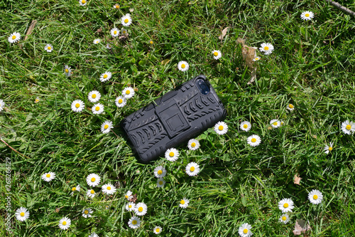 Fototapeta Naklejka Na Ścianę i Meble -  Smart phone in the grass. Lost phone