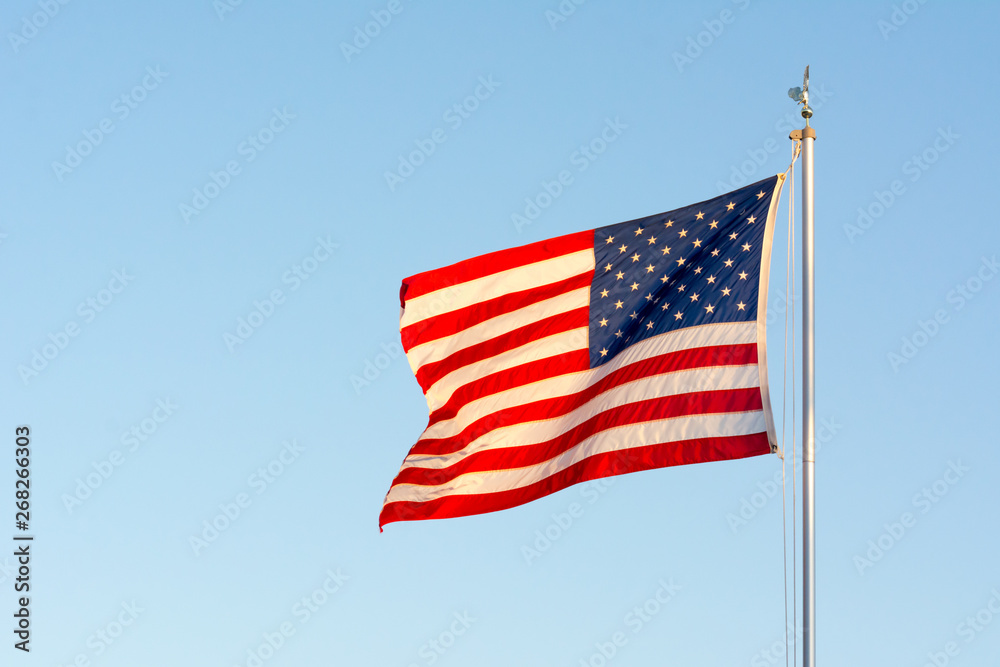 American National Flag Flitting in the Wind on Blue Sky BAckground American National Flag Flitting in the Wind on Blue Sky BAckground