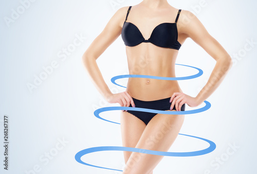 Fit and slender woman in swimsuit. Perfect female shape. Medicine, weight loss, fat burn and healthcare. © Acronym