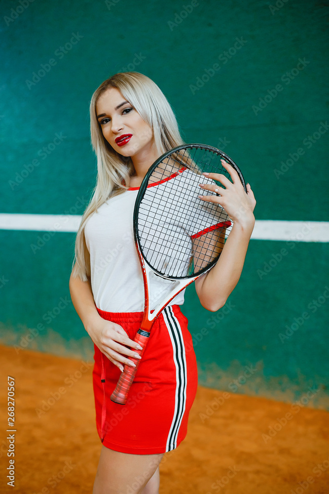 Girl on the tennis court. Stylish lady in a sports clothes