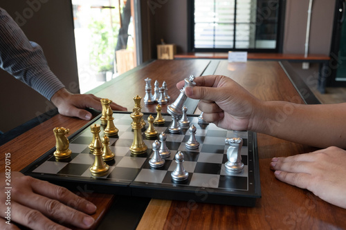 Close-up photos of checkmate hands on a chessboard during a chess game The concept of business victory strategy wins the intelligence game.