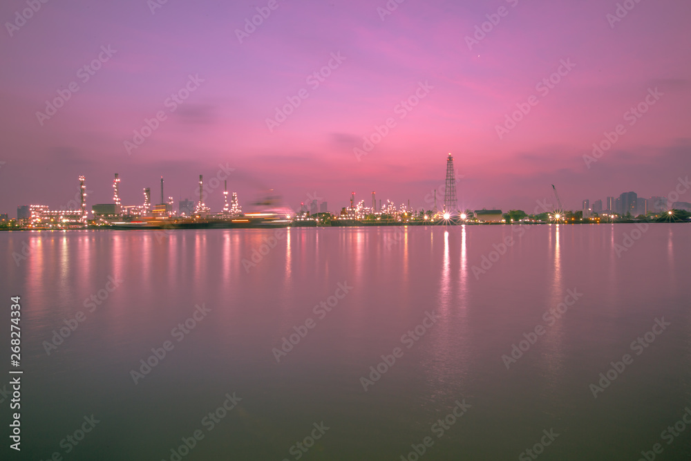 The blurred background of nature along the river, with views of the cargo ship, oil refinery, sunrise and beautiful sky in the morning 