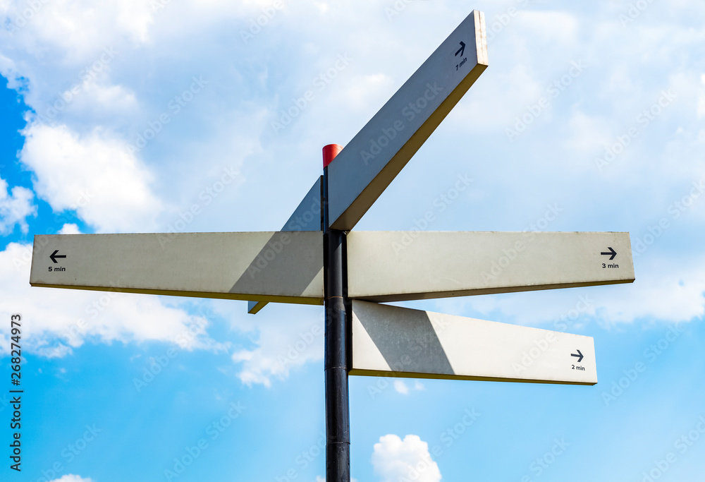 Blank signpost with many directions against blue sky in sunny day. Mockup. copy space Blank signpost with many directions against blue sky in sunny day. Mockup. copy space