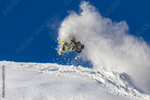 a guy on a snowmobile in a jump makes a pipe with a trace of snow. beautiful flight of a snowmobile after a jump. bright snowmobile and suit without brands. extra high quality