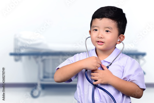 Asian Thai kid with medical stethoscope looking at camera, healthy concept.