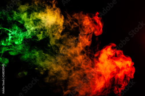 Beautiful horizontal column of smoke in the neon bright light of red, green, yellow and orange on a black background exhaled out of the vape. Nice pattern for printing and backdrop of colored waves. © Aleksandr Kondratov