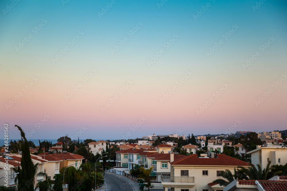 Beautiful landscape panoramic photo of country houses near the sea on the sunset background. copy space. place text