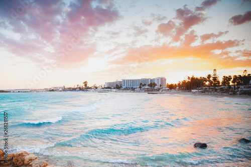 A delightful gentle sunset on the blue sea coast with hotels in pastel shades