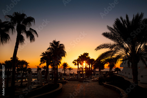 Beautiful golden sunrise on the site of the silhouette of palm trees