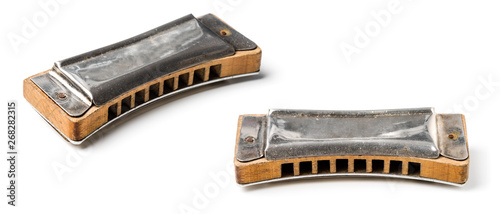 vintage harmonica isolated over white background photo