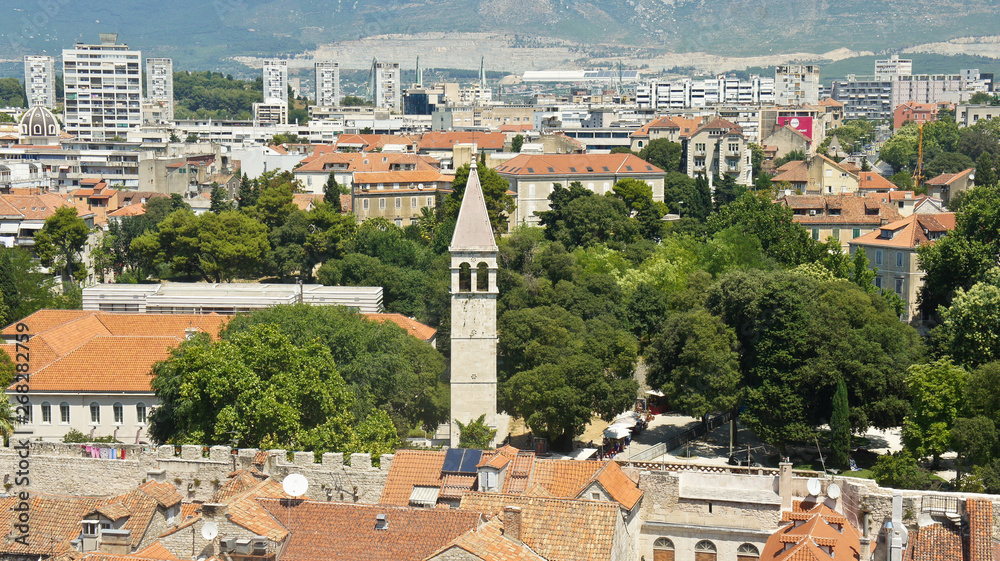 Top view of the city from the bell tower, roofs of houses and church in old town, beautiful cityscape, sunny day, Split, Croatia