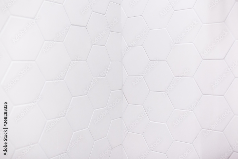 real photo of white hexagonal tiles wall of the bathroom
