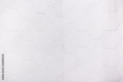 real photo of white hexagonal tiles wall of the bathroom