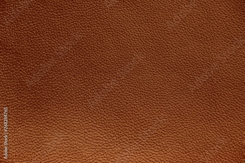 The texture of genuine leather. Impeccable and stylish background. Beautiful stylish background. Natural skin texture close up. Brown background. The structure of the leather material brown shades.