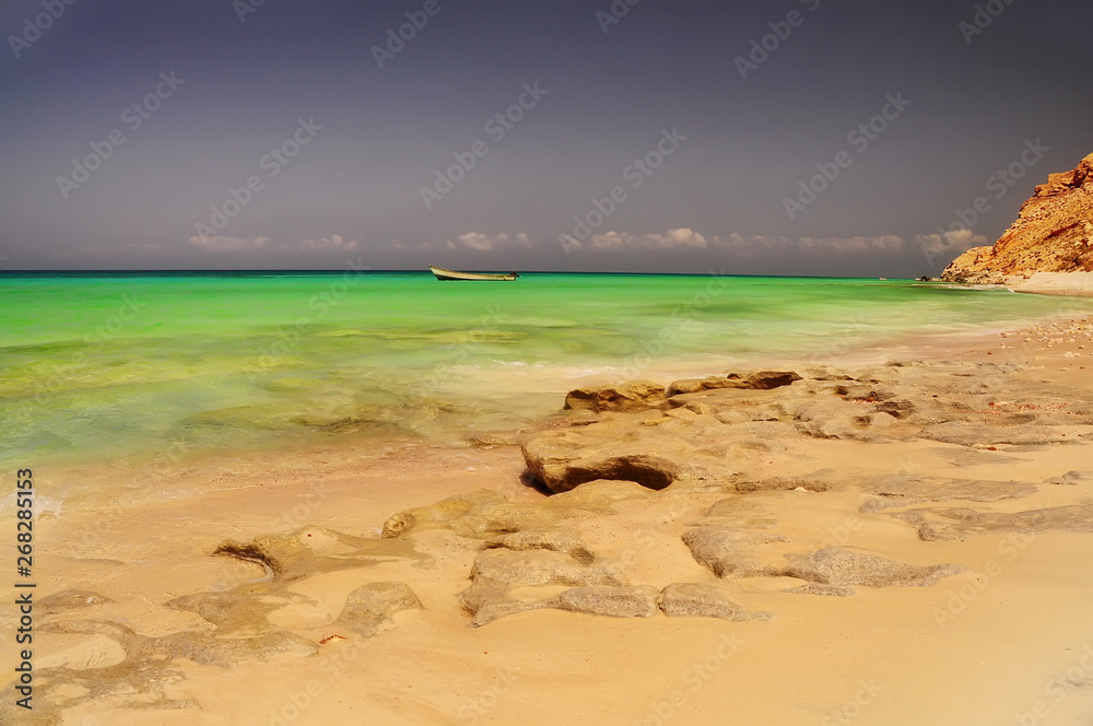 Fantastic deserted beach on the Indian Ocean among the rocks. Paradise vacation.