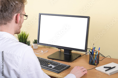 Office worker at the workplace at the computer with copy space on the monitor.Looking at Something on the Computer Screen