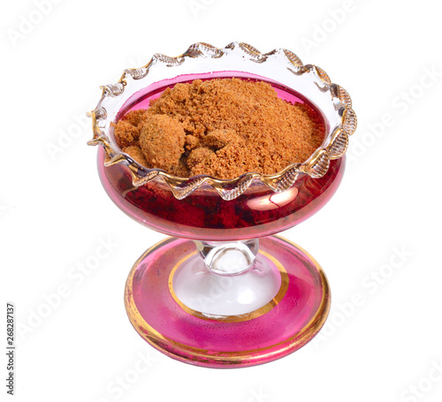 Coconut sugar in wintage glass bowl. Isolated on white background photo