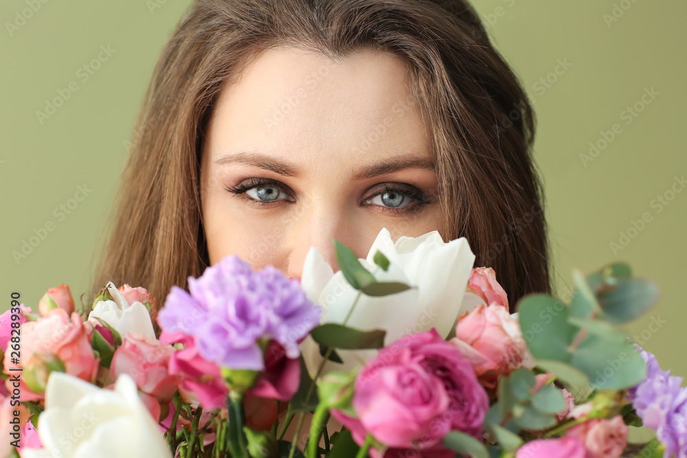 Beautiful young woman with bouquet of flowers on color background Beautiful young woman with bouquet of flowers on color background