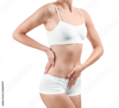 Beautiful young woman in underwear on white background. Plastic surgery concept