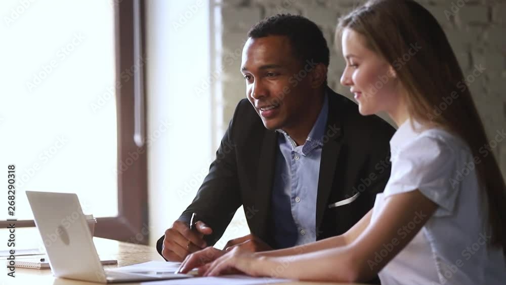 African manager make business offer to caucasian client with laptop