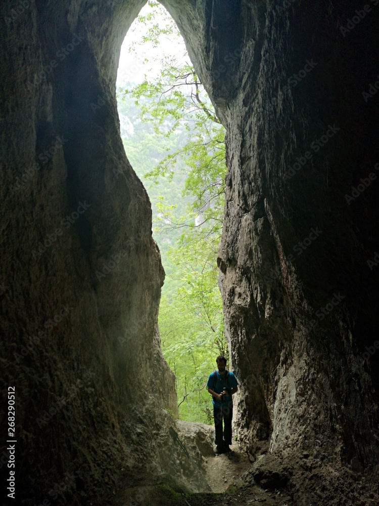 Silhouette at the entrance of the cave  - The Steam Cave in Baile Herculane - is a landmark attraction in Romania