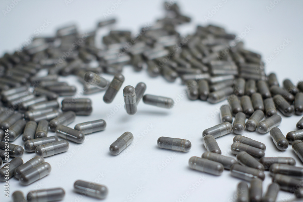 Set of grey capsules pills on white background. Medical preparations. Set of grey capsules pills on white background. Medical preparations.
