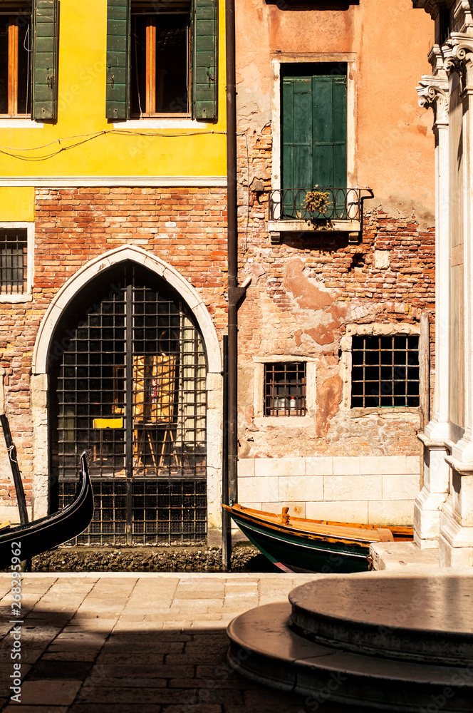 facade in Venice with gondola and church entrance