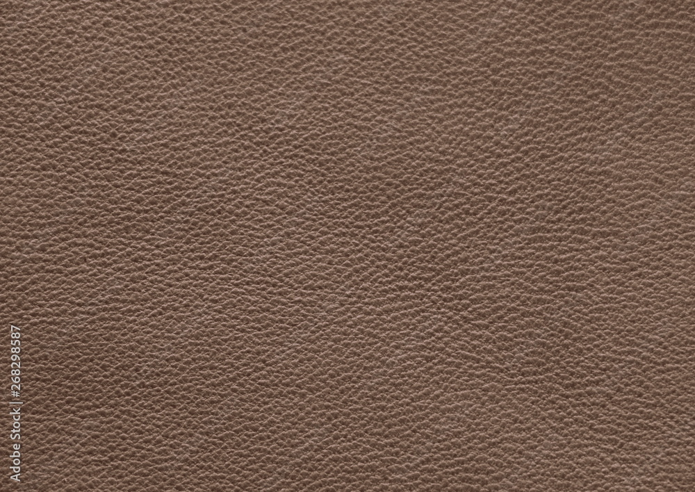 The texture of genuine leather. Impeccable and stylish background. Beautiful stylish background. Natural skin texture close up. Brown background. The structure of the leather material brown shades. The texture of genuine leather. Impeccable and stylish background. Beautiful stylish background. Natural skin texture close up. Brown background. The structure of the leather material brown shades.