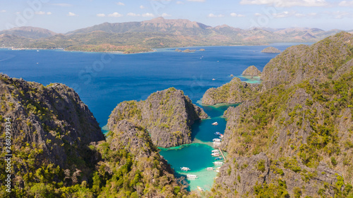Twin Lagoon in Coron, Palawan, Philippines. Mountain and Sea. Lonely Boat aerial view