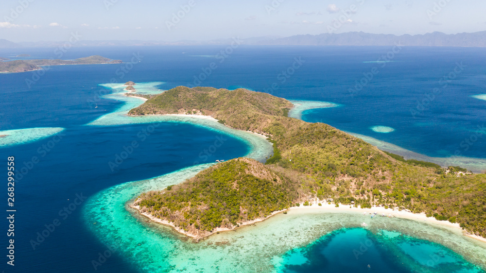 SmSmall islands with a sand bar. Coral reefs and blue lagoons. islands with a sand bar. Malay Archipelago, Philippines aerial view