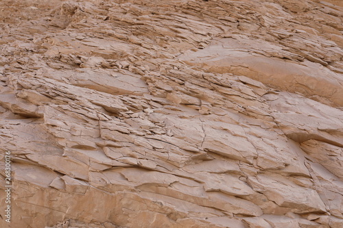 Texture of stone mountain in the desert of Egypt. Great for creative background in pastel colors. Natural textured stone background in light beige color. 